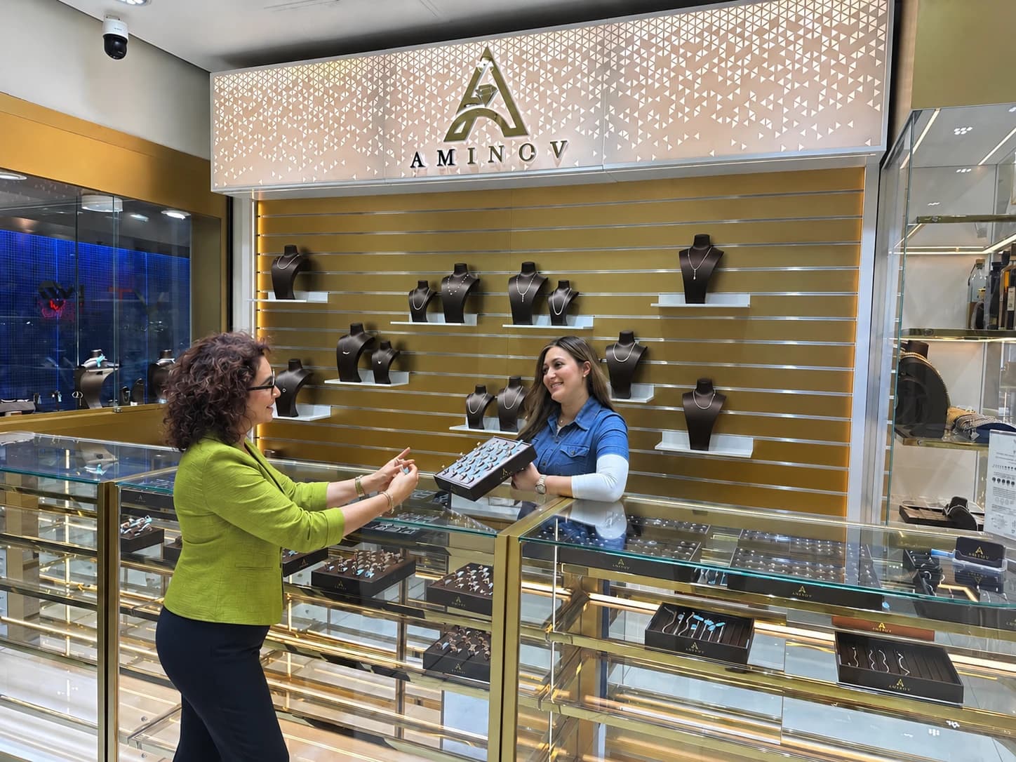 A tray of rings shown at the counter under the AMINOV sign in the showroom